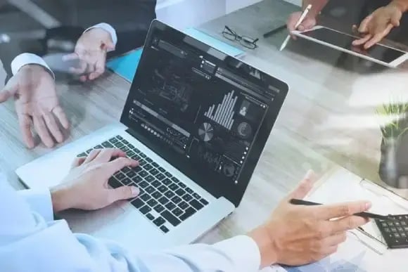 business documents on office table with smart phone and laptop computer and graph financial with social network diagram and three colleagues discussin (1) (1)