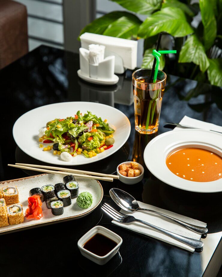 lunch-setup-with-lentil-soup-fresh-vegetables-salad-sushi-plate_140725-263